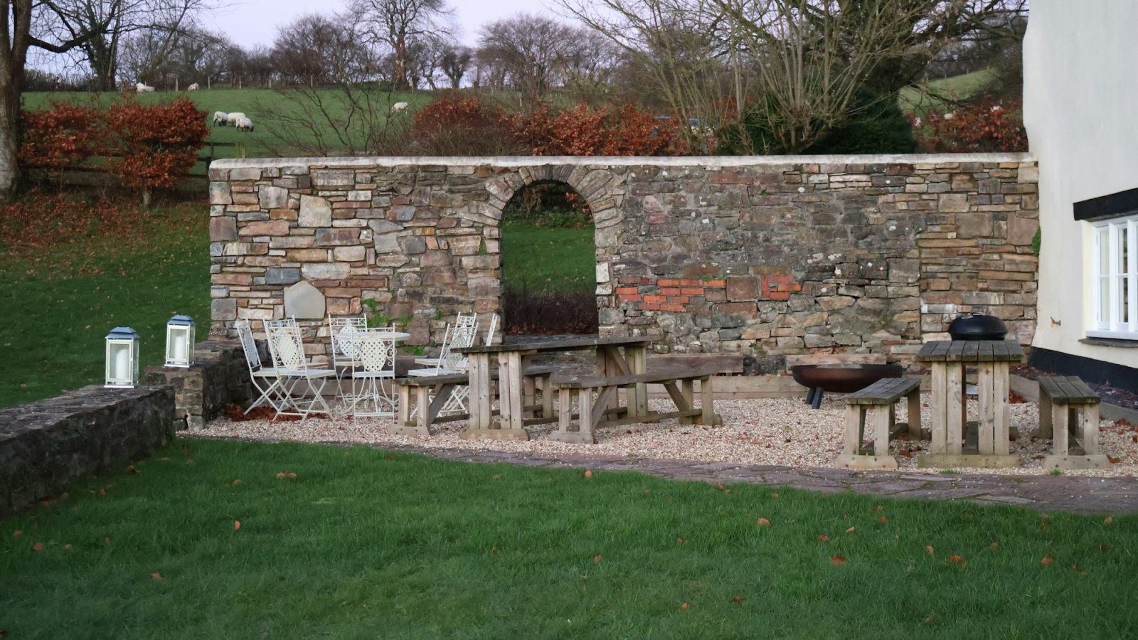 An outdoor patio with stone walls and furniture